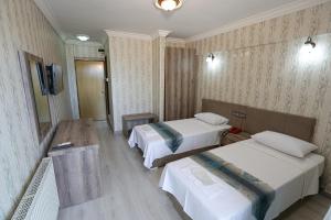 Postel nebo postele na pokoji v ubytování Cagdas Hotel