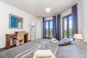 a bedroom with two beds and a desk and windows at Villa Cavallo in Linardići +40 photos