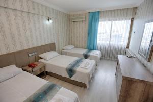 Postel nebo postele na pokoji v ubytování Cagdas Hotel
