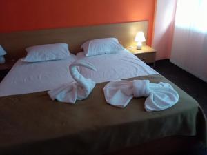 A bed or beds in a room at Family Hotel Varna