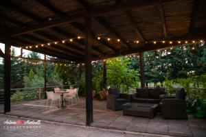 a pavilion with a table and chairs and lights at La Torre-1984 in Sarnelli +28 photos
