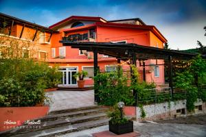 an orange house with a staircase in front of it at La Torre-1984 in Sarnelli