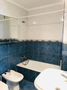 a bathroom with a sink and a toilet and a mirror at Apartamento Bonitas Vistas in Luanco