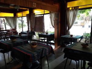 a dining room with tables and chairs and windows at Hotel La Marina in Villa Carlos Paz +24 photos