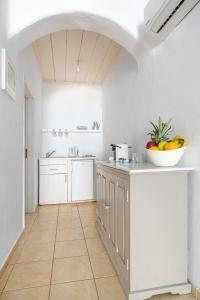 a kitchen with a bowl of fruit on the counter at Ornos Blue in Ornos