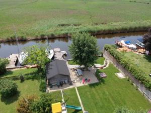 an aerial view of a house next to a river at GARDEN Apartment PLUS private Beach in Neusiedl am See