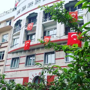 a building with red signs on the side of it at Hali Hotel in Istanbul
