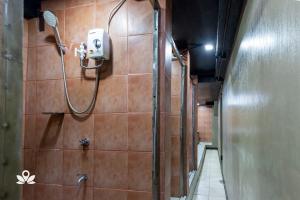 a bathroom with a shower with a shower head at 3BU Hostel Baguio - Bonifacio in Baguio