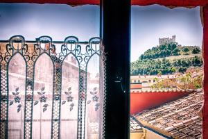 a window with a view of a mountain at CASAS LA MURALLA de Bodegas Marcos in Peñafiel +28 photos