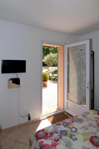 a bedroom with a bed and a sliding glass door at Villa Louanne in Pertuis