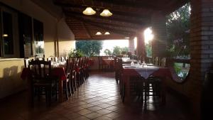 a dining room with tables and chairs in a restaurant at Europa rooms Capo Vaticano in Capo Vaticano
