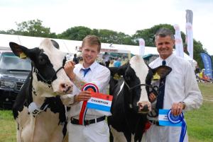 two men are holding two cows with their awards at Trecorme Barton in Quethiock
