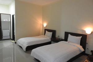 Postel nebo postele na pokoji v ubytování D'Batur Hotel