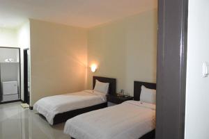 Postel nebo postele na pokoji v ubytování D'Batur Hotel