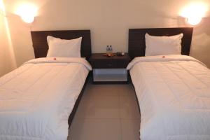 Postel nebo postele na pokoji v ubytování D'Batur Hotel