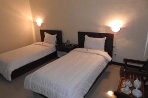 Postel nebo postele na pokoji v ubytování D'Batur Hotel