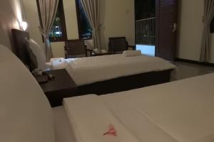Postel nebo postele na pokoji v ubytování D'Batur Hotel
