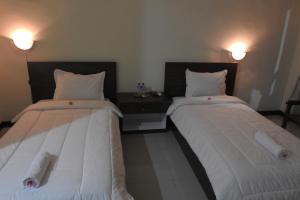 Postel nebo postele na pokoji v ubytování D'Batur Hotel