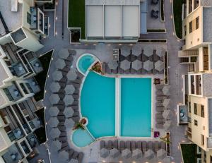 an overhead view of a swimming pool in a city at Porto Platanias Beach Luxury Selection - Adults Only in Plataniás