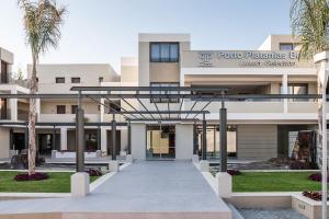 a view of the front of the four palms building at Porto Platanias Beach Luxury Selection - Adults Only in Plataniás