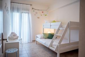 a small room with a bunk bed and a couch at Oikia Eleanthi - Beachfront Garden Home! in Mitikas +41 photos