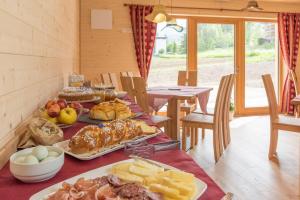 a table with many different types of food on it at Eco-Green Fiores Agriturismo in Vigo di Fassa