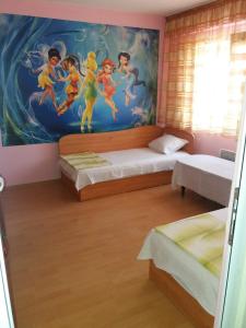 a room with two beds and a painting on the wall at Comfortable 2-bedroom apartment in Burgas