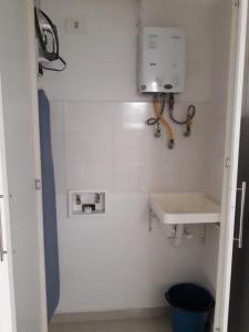 a bathroom with a sink and a soap dispenser at Amoblados Rugeles edificio stradastradasuites in Bucaramanga