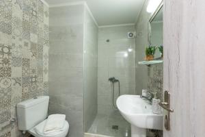 a bathroom with a toilet and a sink at Elena's Apartment in Panormos Rethymno +27 photos