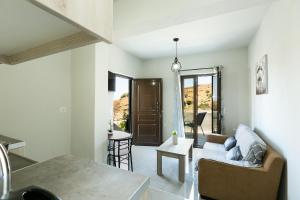 a living room with a couch and a table at Elena's Apartment in Panormos Rethymno