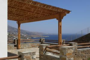 a wooden pavilion with a view of the ocean at Monolithos Villas in Kipri