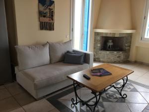 a living room with a couch and a coffee table at Monolithos Villas in Kipri