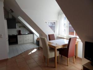 eine Küche und ein Esszimmer mit einem Tisch und Stühlen in der Unterkunft Ferienwohnung über den Dächern in Lindau