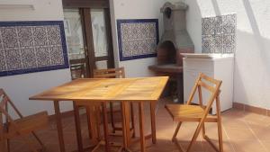 a wooden table and chairs in a kitchen with a stove at La Casa Blanca in Grottammare
