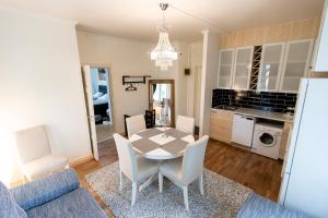 a dining room and living room with a table and chairs at Klintvägen Apartments in Mariehamn +70 photos