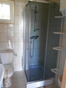 a shower with a glass door in a bathroom at KANZAS in Jarosławiec +43 photos