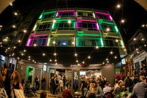 a crowd of people standing in front of a building at Graffi City House in Florianópolis