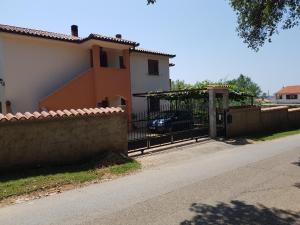 een hek voor een huis met een hek bij Apartments Iva in Pula