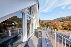 a balcony with chairs and a view of the mountains at Ferienwohnung Bella Vista in Bernkastel-Kues