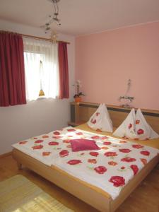 a bedroom with a large bed with flowers on it at Ferienhaus Pirker in Eisentratten
