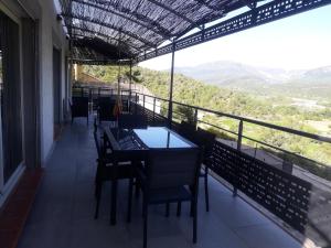 a table and chairs on a balcony with a view at Villabellevie in Bras-dʼAsse