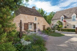 a stone house with a garden in front of it at Hôtel Le Clos in Montagny-lès-Beaune
