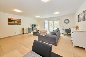 a living room with two couches and a table at Ferienwohnung Bella Vista in Bernkastel-Kues