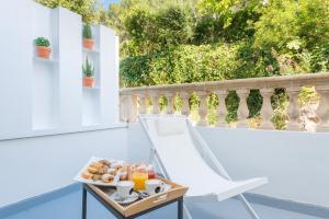 a tray of breakfast food on a balcony at Boutique Hotel Oriola in Cala de Sant Vicenc