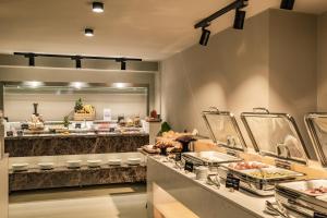 a kitchen with a counter with food on it at Doryssa Boutique Hotel in Pythagoreio