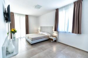 A bed or beds in a room at Vasto Aparthotel