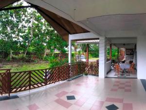 an open deck with a view of a park at RTMS Guesthouse Semporna in Semporna
