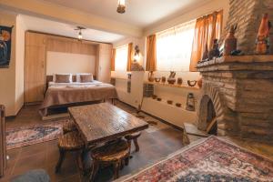 a bedroom with a bed and a fireplace at Guest House MK in Gori