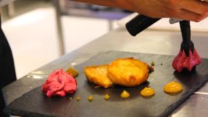 a person is cooking food on a counter at AVANTI Lifestyle Hotel - Only Adults in Corralejo