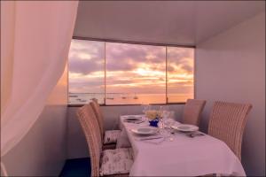 a dining room with a table and a large window at AVANTI Lifestyle Hotel - Only Adults in Corralejo